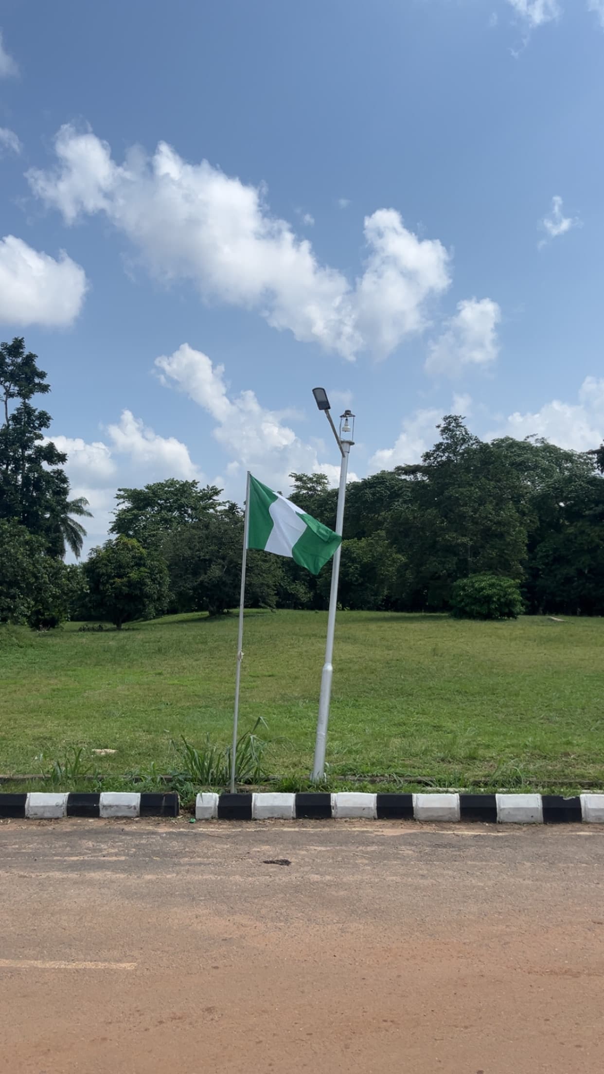 Nigerian flag flying against blue sky