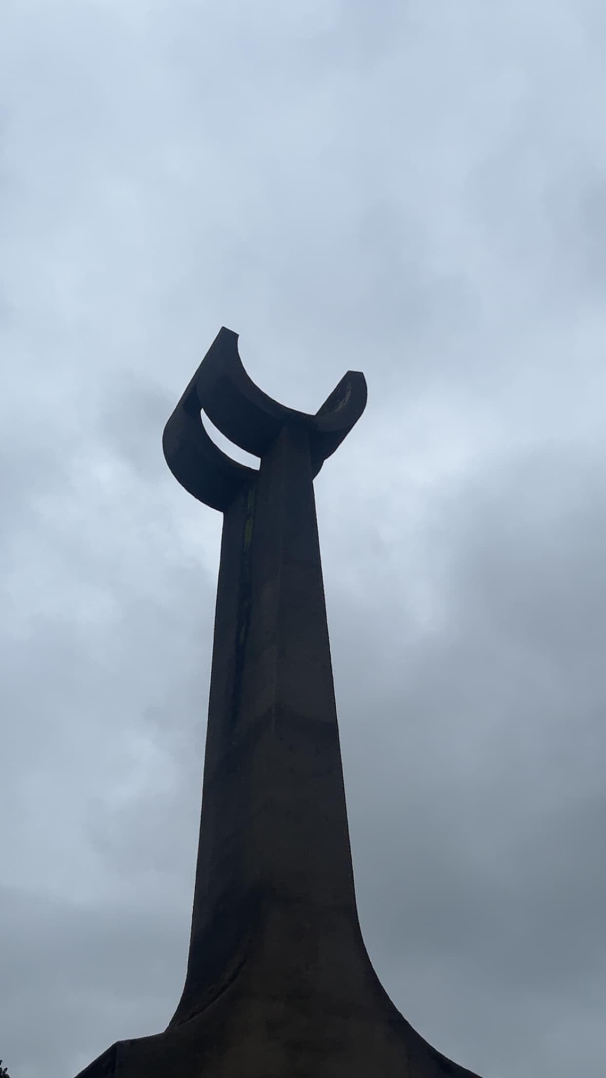 OAU monument silhouette against overcast sky